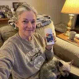 Woman on an armchair with her small dog