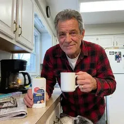 Man in his kitchen with his dog
